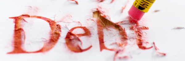 Pink eraser removing red text spelling 'Debt' on white paper shredding the word.