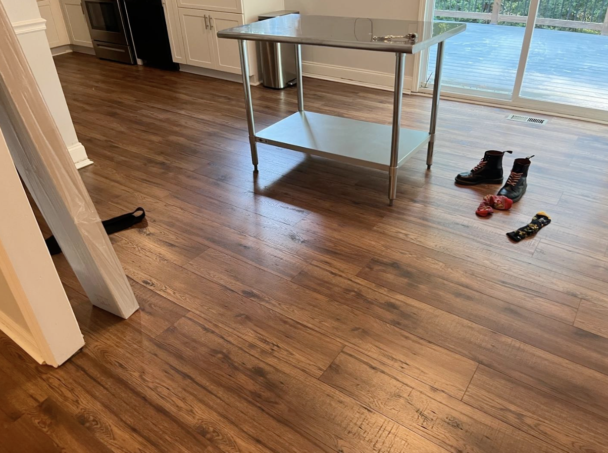 860 sq ft Aqua Pro wide-plank laminate with subfloor repairs installed in Woodstock, GA by Concept Flooring