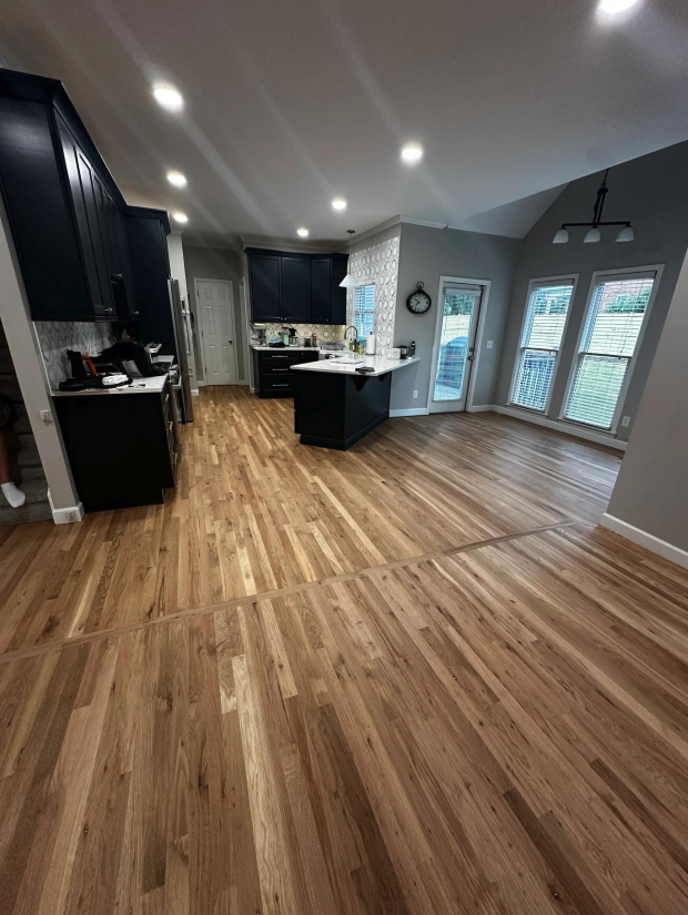 Sanded and refinished hardwood floors with new wood blended into the existing floor in a Marietta, GA home
