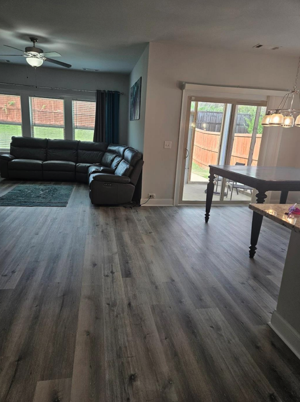 Freshly installed laminate flooring across the downstairs living area of a Woodstock, GA home, completed by Concept Flooring
