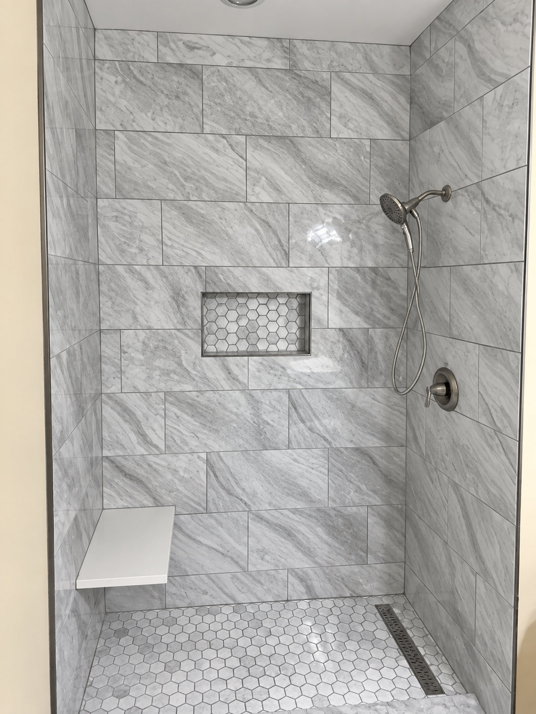 Three bathroom projects of different sizes, from a shower re-tile to a full primary bath
