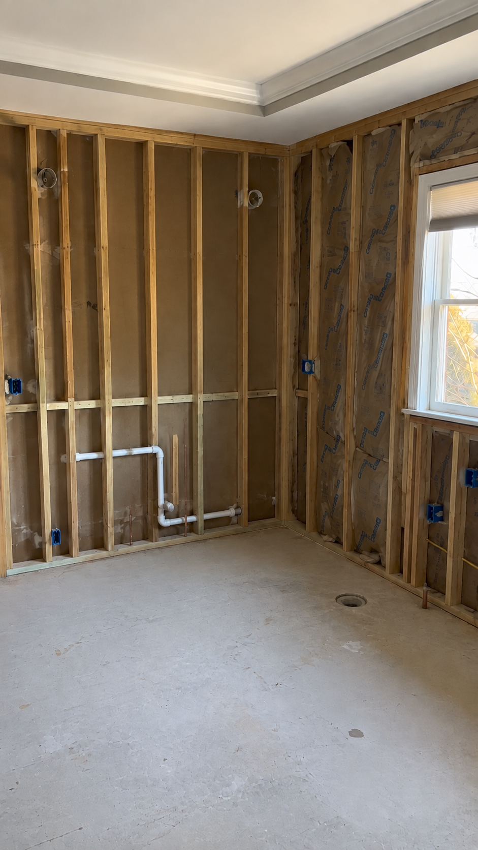 Shower walls opened up during demolition, exposing the framing behind the tile