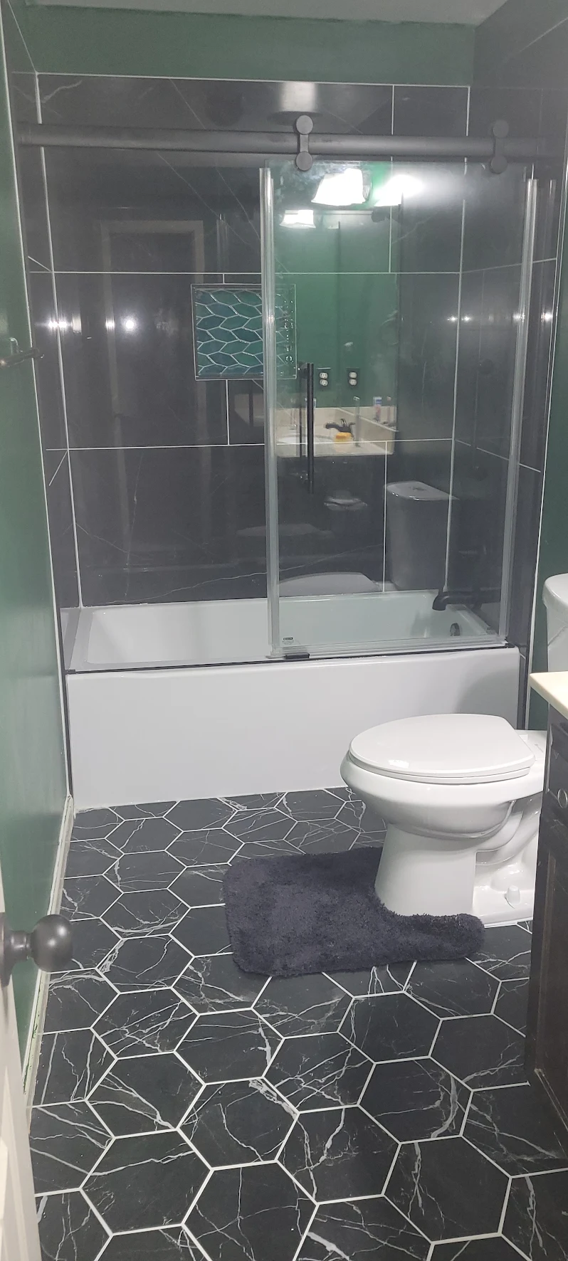 Bathroom mid-remodel with the shower, toilet and vanity kept in their original positions