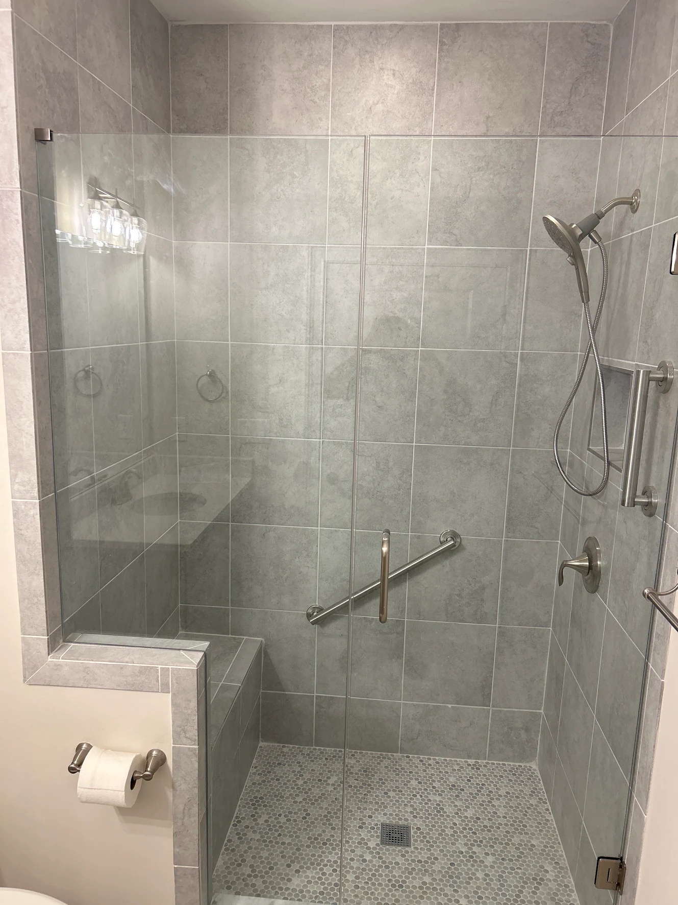 Tiled walk-in shower with a glass enclosure