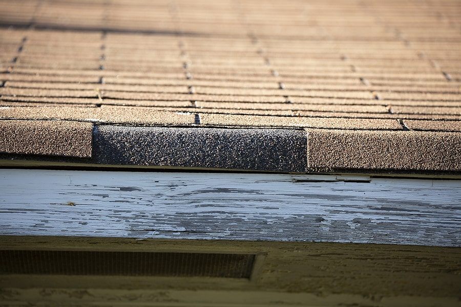 A shingle missing on top of a roof