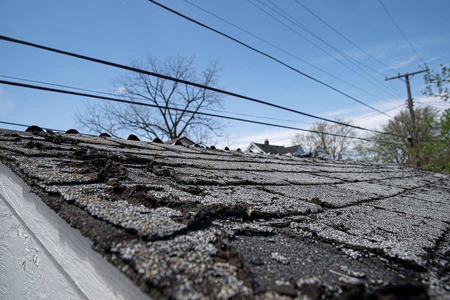 Damaged shingles on top of a roof