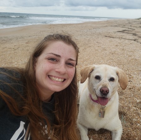 Ashley S with her dog on a beach