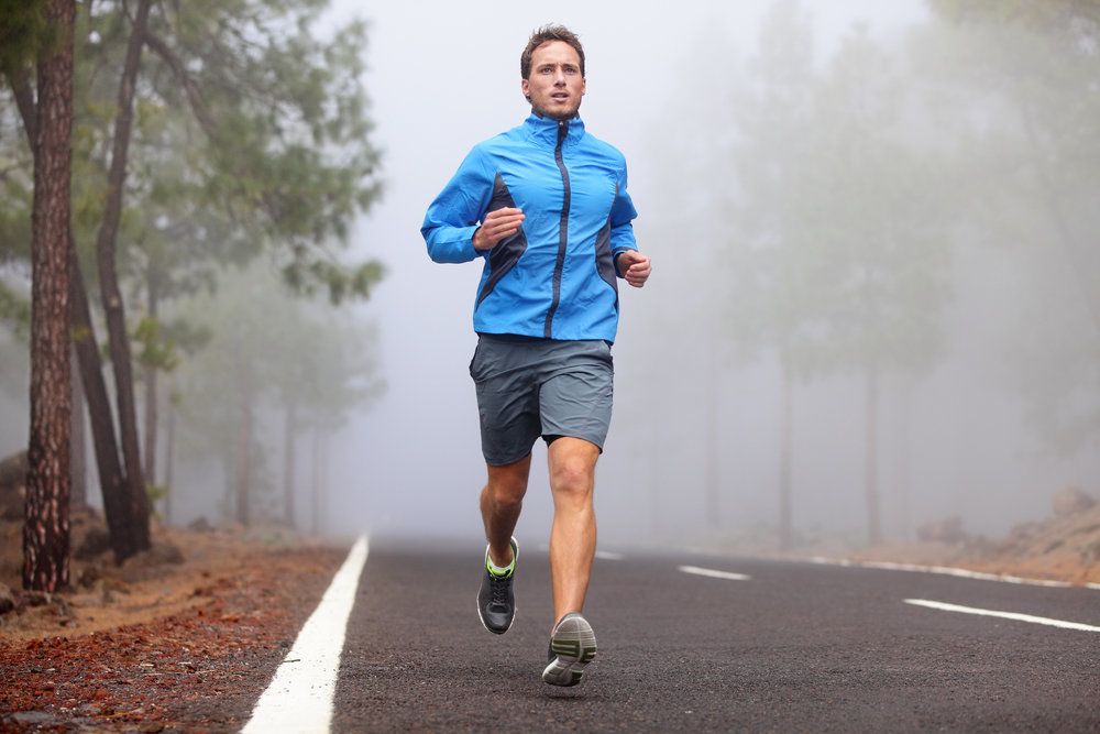 man jogging on outdoor trail