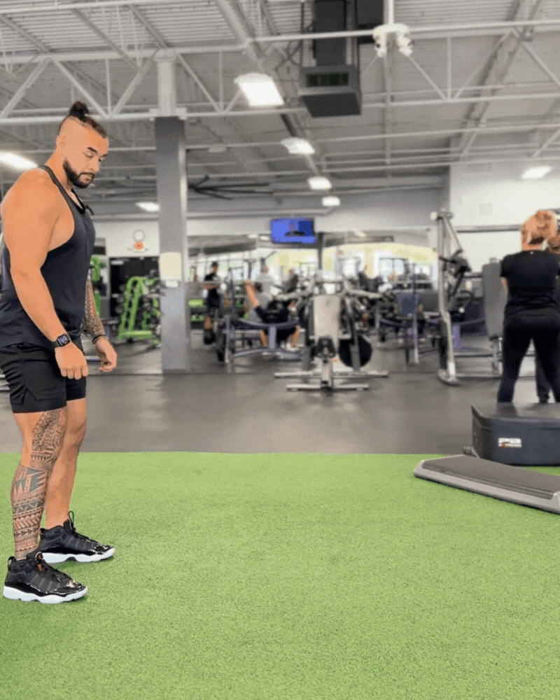 Personal trainer demonstrating broad jump.