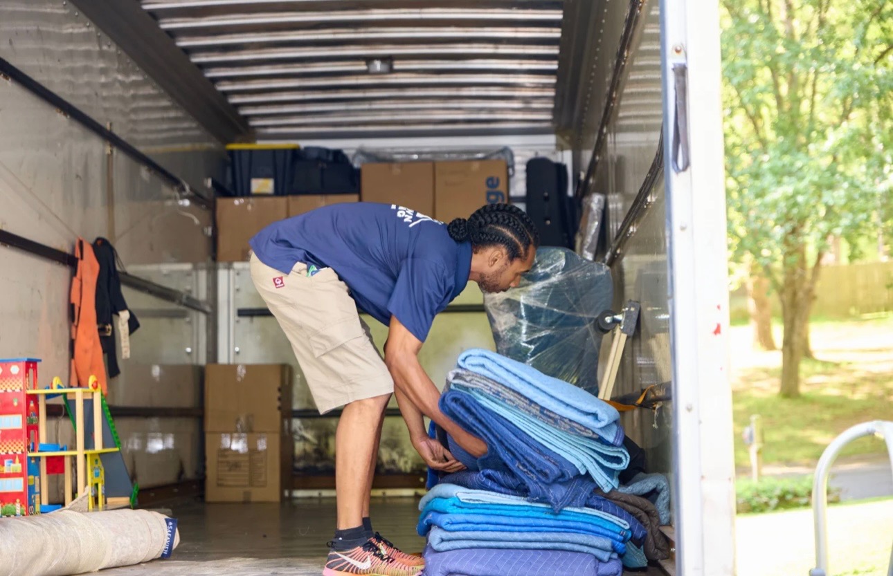 Midtown mover stacking moving blankets inside the truck before loading