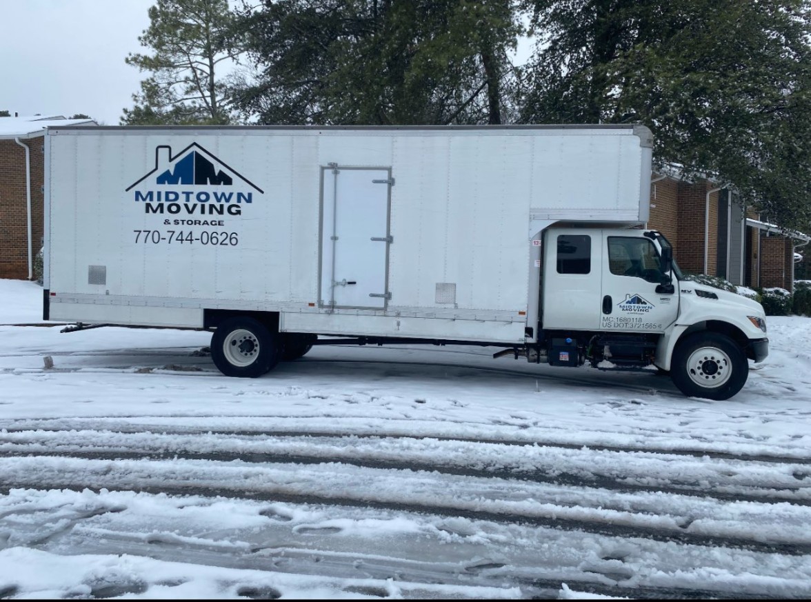 Midtown Moving truck on a snowy highway during a long distance run to Macon