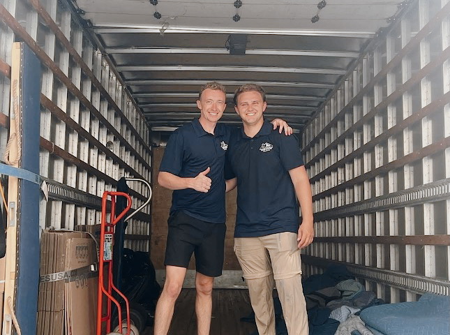 The Midtown Moving crew in uniform standing in a Midtown truck