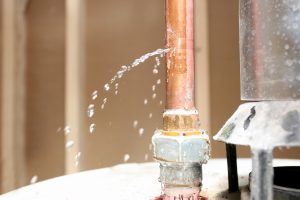 Water leaking out of a pipe on water heater.