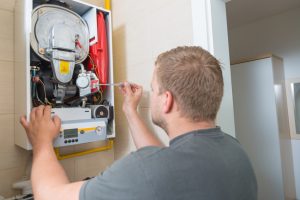 Technician repairing Gas Furnace.