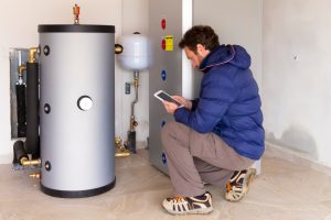 plumber at work on hot water heater