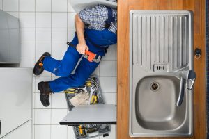 Plumber Examining Sink