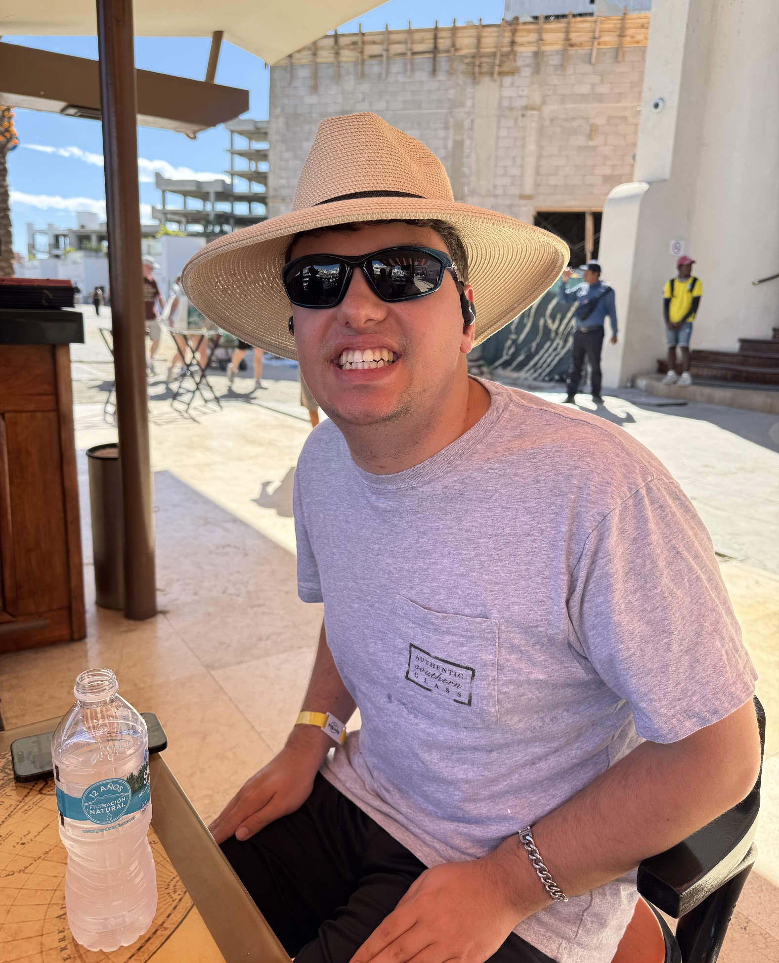 A man smiling on vacation by the water