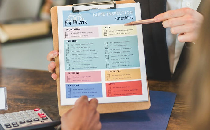 Colorful checklist of items to inspect before buying a house, held up on a clipboard