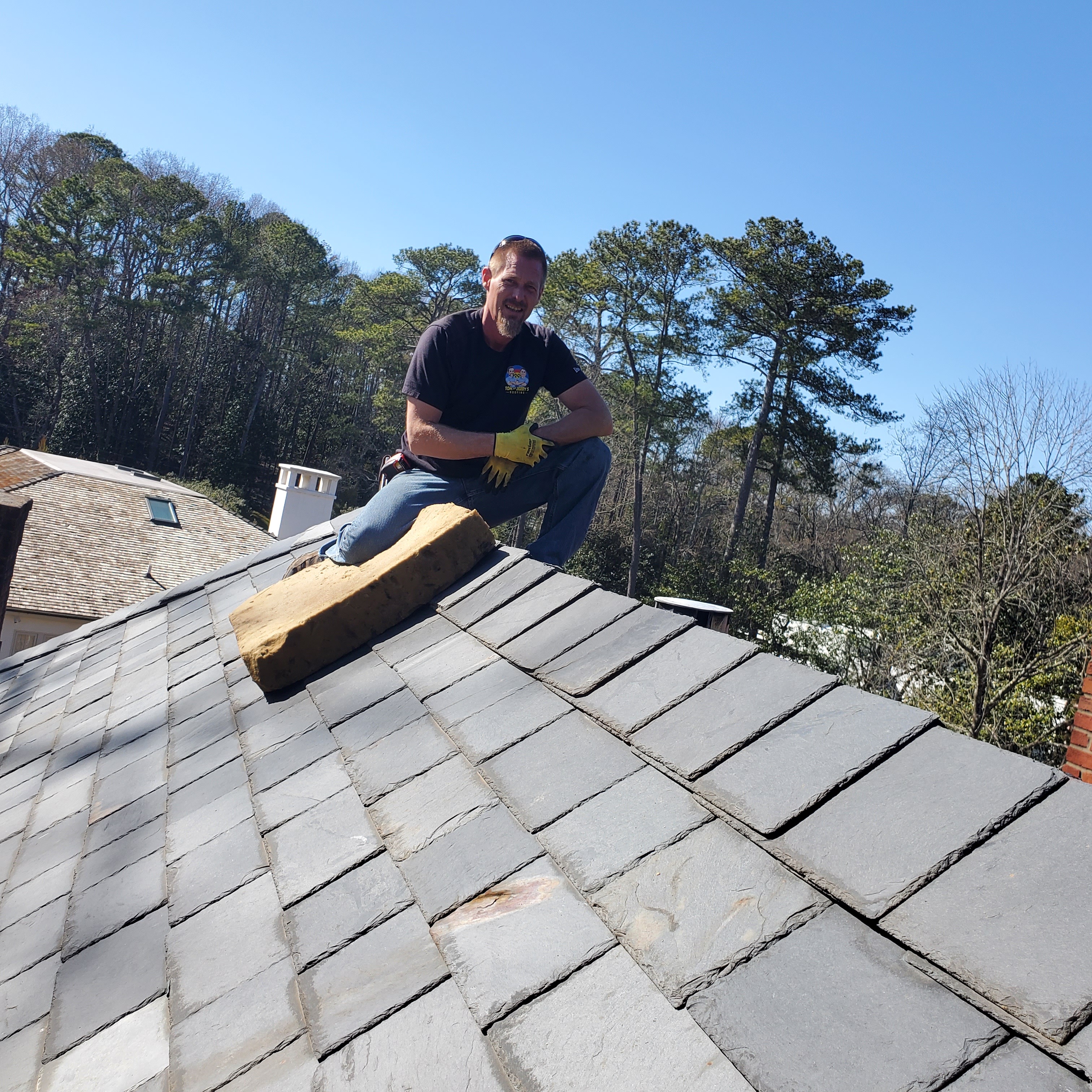 John Roberts, Quality Control and Production Manager at Tom and Jerry's Roofing, standing confidently, showcasing his 25 years of roofing expertise.