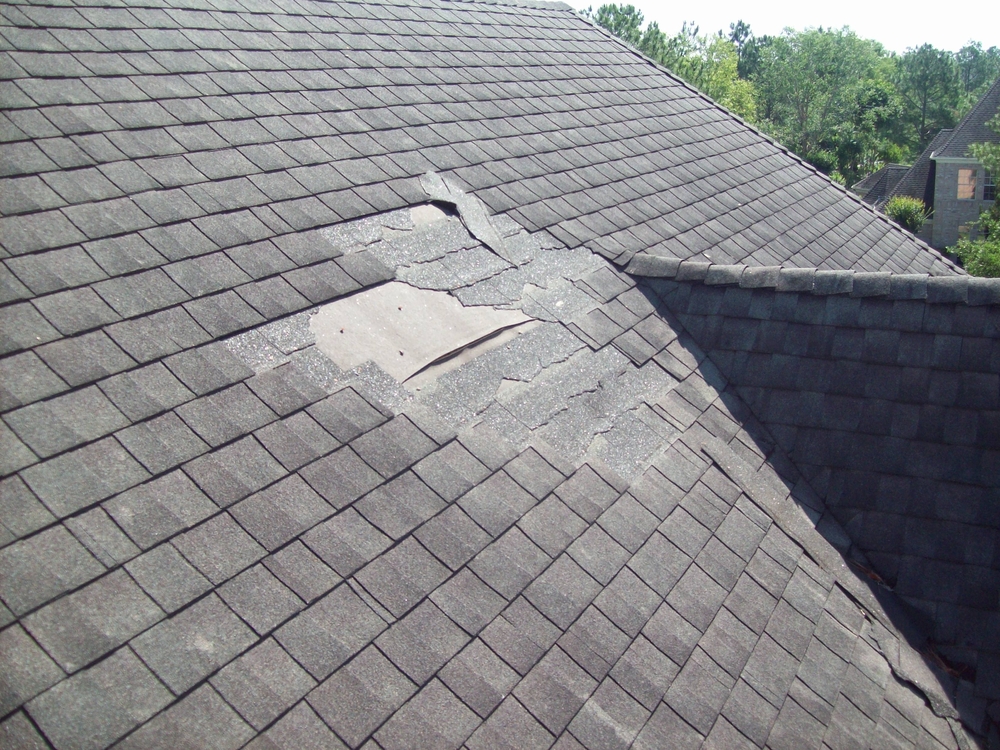 Residential roof missing shingles following severe weather - Tom and Jerry's Roofing